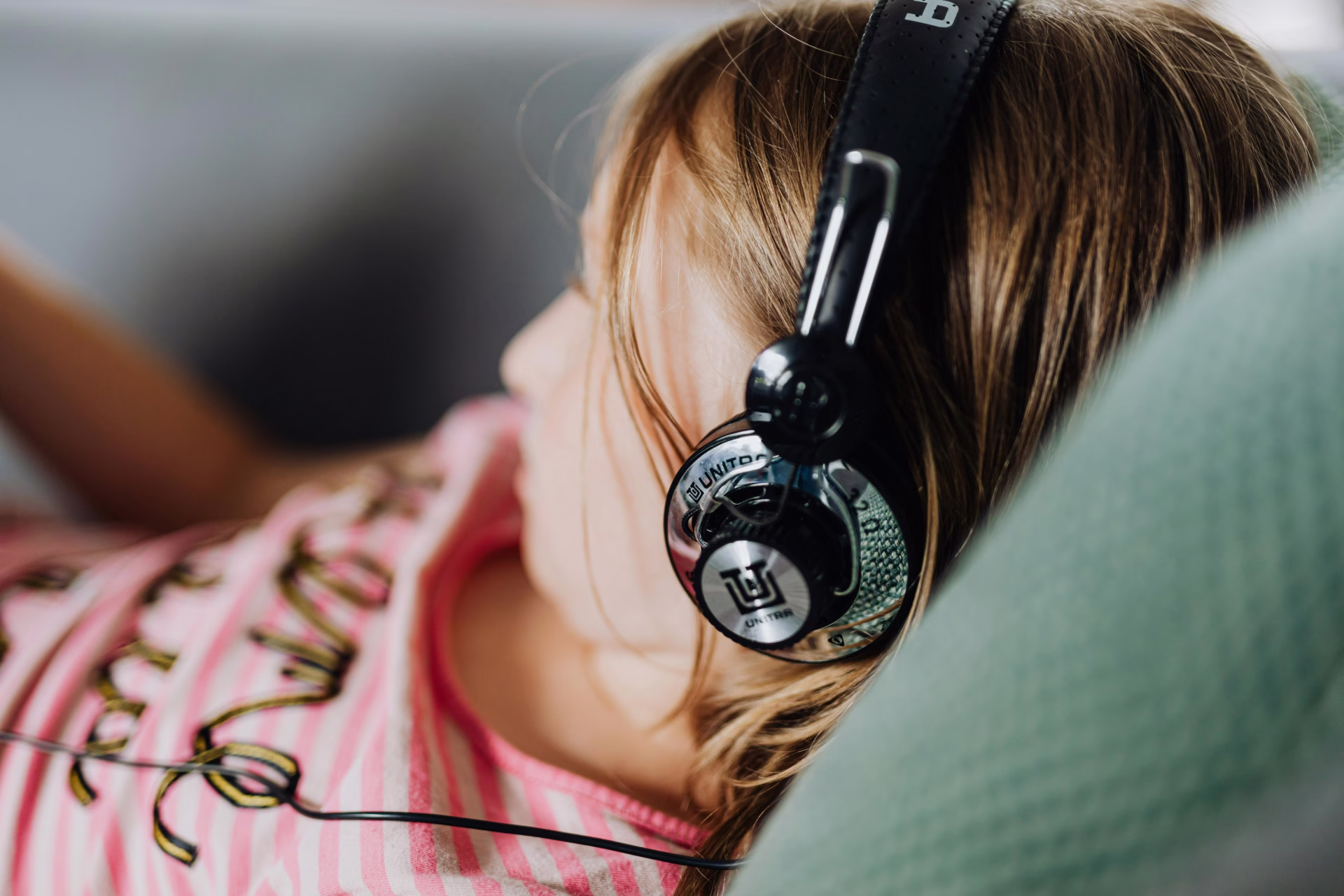 Autistic twin girl wearing headphones.