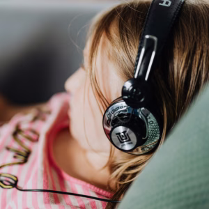 Autistic twin girl wearing headphones.