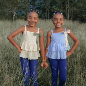 Smiling Twin Sisters Holding Hands