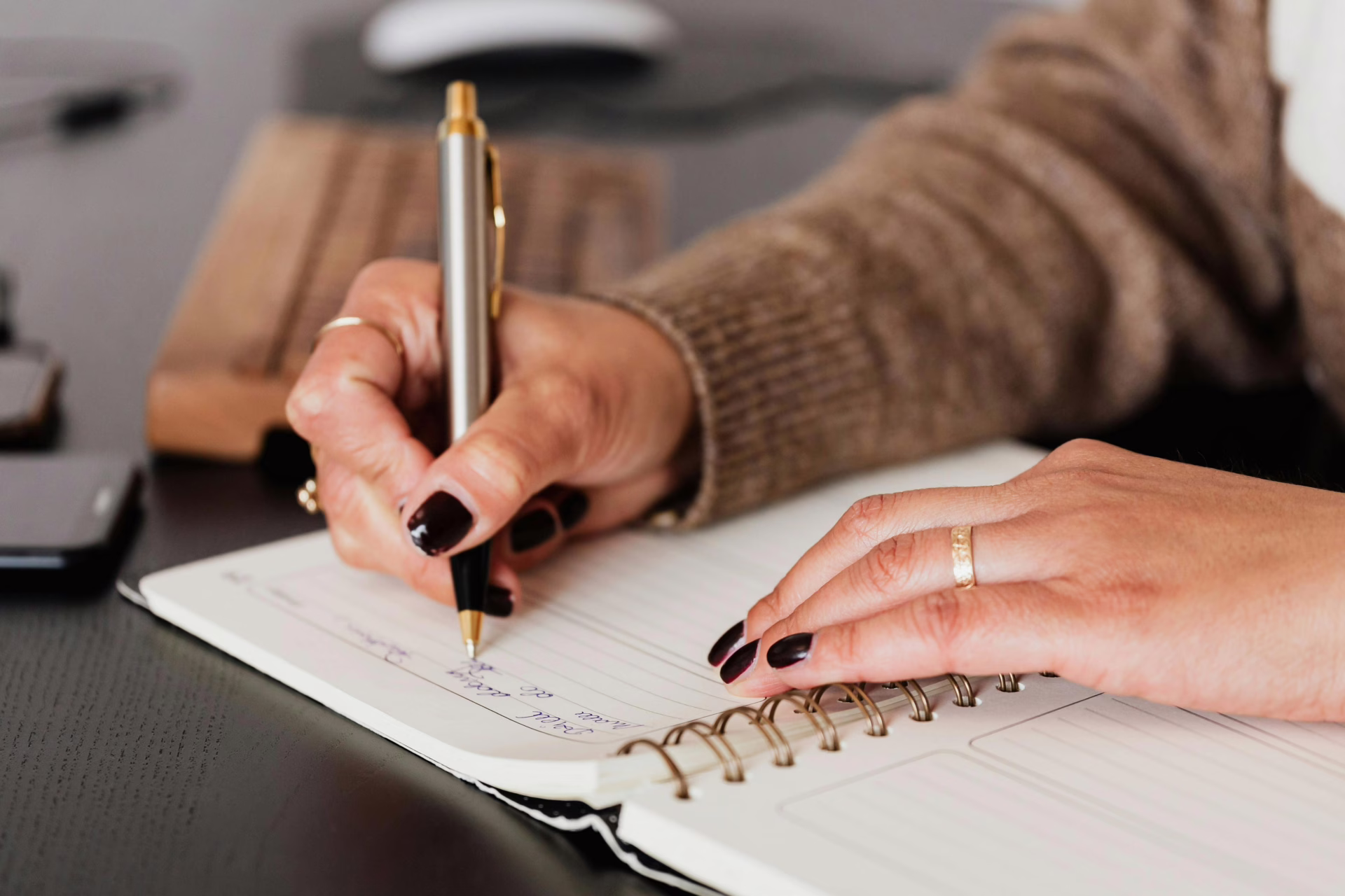 Closeup of woman writing in a journal