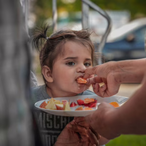 autistic twin girl eating fruit