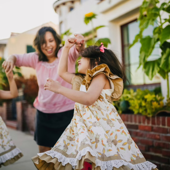 Mother dancing with autistic twin girls