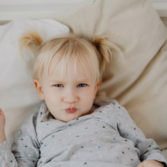 Autistic twin girl in bed